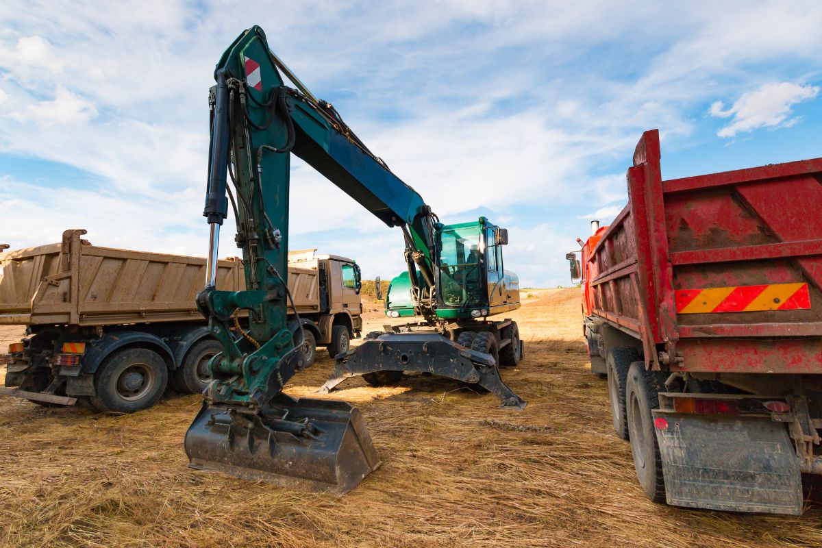 Excavator and dump truck operating on an active construction site