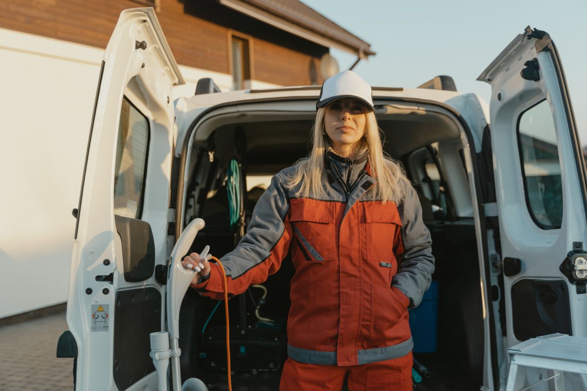 HVAC service van parked curbside with technician loading tools