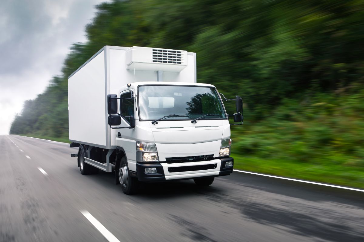 Refrigerated delivery truck unloading at a grocery dock