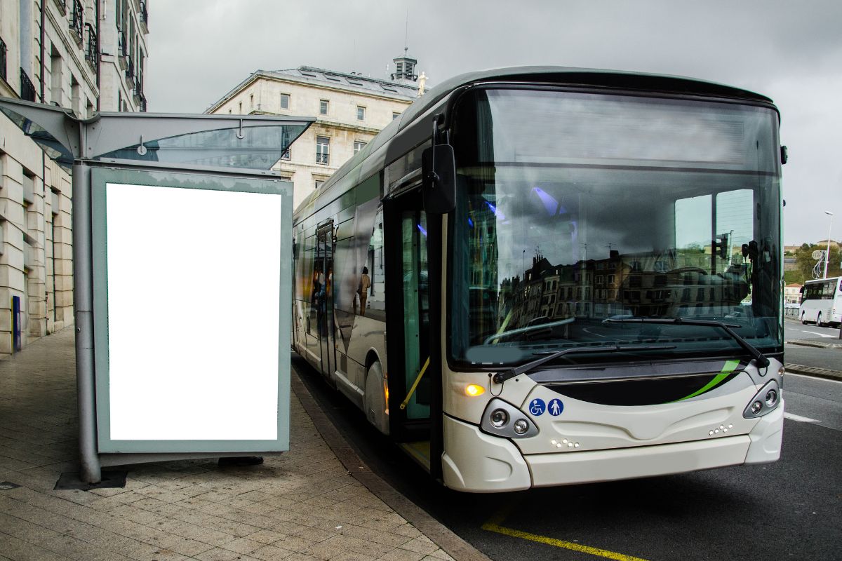 City bus arriving at a stop with passengers boarding